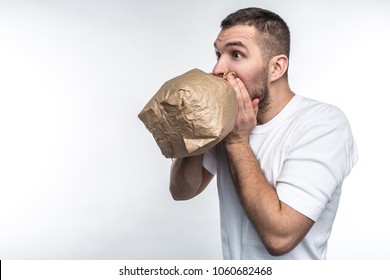 Man suffering from a stress attack. He is trying to come calm down. Isolated on white background.