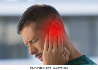 Man Suffering From Strong Earache Or Ear Pain. Ear Inflammation, Otitis Or Tinnitus