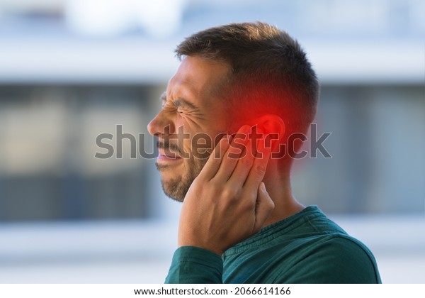 Man\
suffering from of strong earache or ear pain.\
Otitis