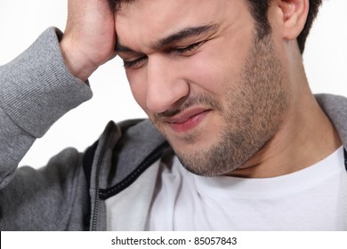 Man Suffering From A Throbbing Headache