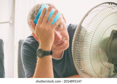 Man Suffers From Heat At Home And Tries To Cool Off By The Fan