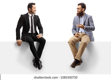 Man in a suit and a bearded man sitting on a blank panel and talking isolated on white background
