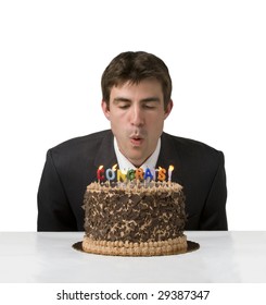 Man In Suit Blows Out Congrats Candles On A Cake