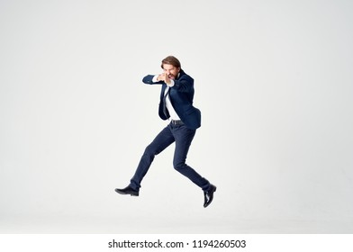 man in a suit bounces and gesticulates                            - Shutterstock ID 1194260503