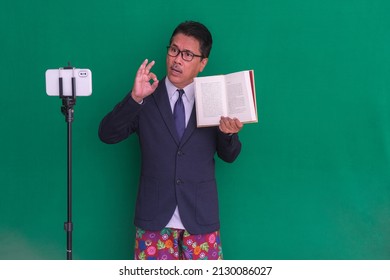 A Man In A Suit And Boxer Shorts Explains Something Online; Serious Expression.