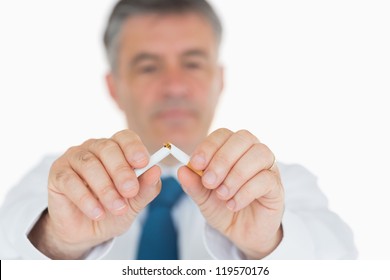 Man In Suit Breaking Cigarette In Half