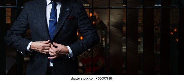 Man In Suit Buttoning His Jacket