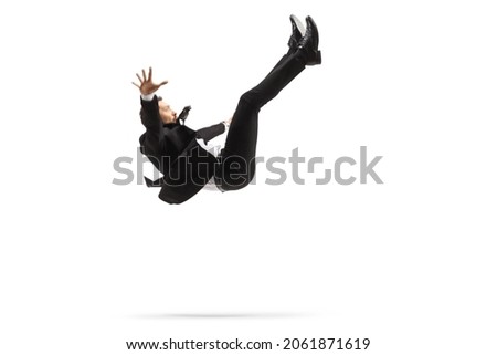 Man in a suit falling down isolated on white background