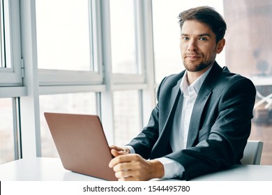 Man In Suit In Front Of Laptop In Office Cropped View