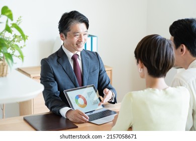 A man in a suit giving an explanation - Shutterstock ID 2157058671