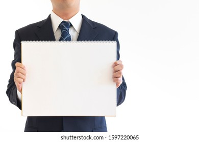 Man In Suit Holding Blank Sketchbook