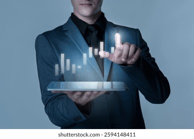 Man in suit interacts with digital graph on tablet. Business, technology, and data visualization. Futuristic interface, professional attire, digital interaction. Corporate business image.