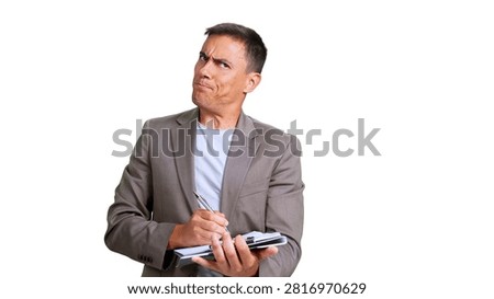 Man in a suit jacket holding a notebook and pen, looking suspicious and scrutinizing