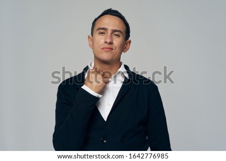 A man in a suit jacket shirt a puzzled look