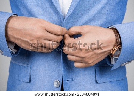 Man in suit jacket unbutton with hands. Business casual style of man, closeup. Male menswear for man in formalwear. Business suit concept. Menswear for man wearing jacket [[stock_photo]] © 