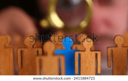 Man in suit look thru loupe on statuettes closeup in office. Success hr assessment people headhunt inspector applicant exchange 404 web error concept