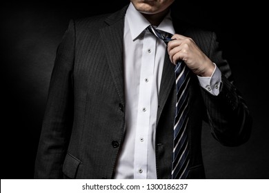 Man With A Suit To Loosen A Tie