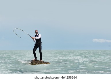 Man in a suit on a desert island, fishing