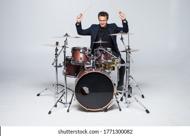 Man in a suit playing drums isolated on white background - Powered by Shutterstock