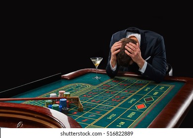 Man In Suit Playing Roulette. Addiction To Gambling.