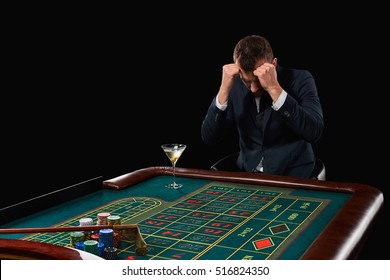 Man In Suit Playing Roulette. Addiction To Gambling.