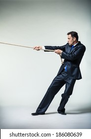 Man In Suit Pulling A Rope