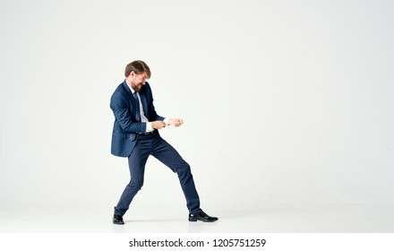 A man in a suit is pulling something.                                - Shutterstock ID 1205751259