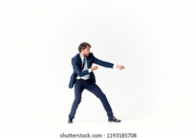 a man in a suit pulls an invisible rope                                - Shutterstock ID 1193185708