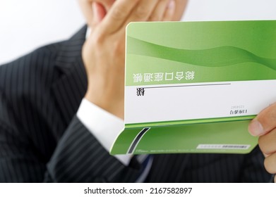 A Man In A Suit With A Savings Passbook Written As 