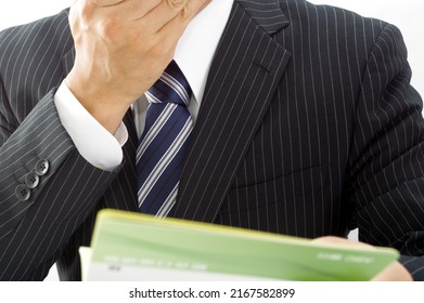 A Man In A Suit With A Savings Passbook Written As 