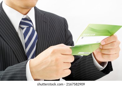 A Man In A Suit With A Savings Passbook Written As 