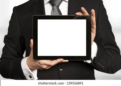 Man in suit, shirt and tie holding a tablet computer with blank display