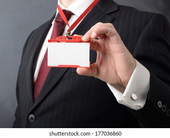 Man In Suit Showing Id Or Name Badge 