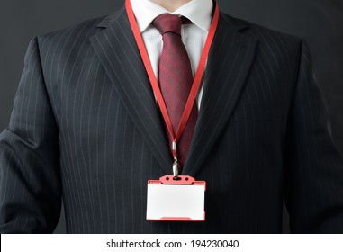 Man In Suit Showing Id Or Name Badge 