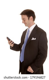 A Man In A Suit From The Side Looking At A Cell Phone.