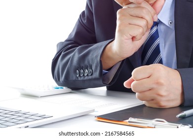 A man in a suit staring at documents seriously