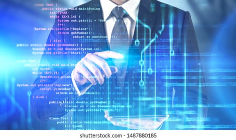 Man in suit with tablet computer working with futuristic immersive code interface. Concept of future of coding and hi tech. Toned image