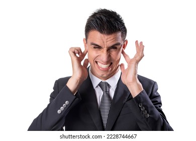Man in suit and tie in agony plugging his ears on a white background - Shutterstock ID 2228744667