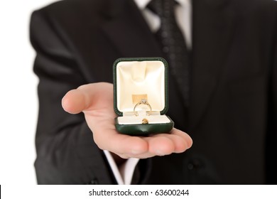 Man In Suit And Tie Holding Engagement Ring