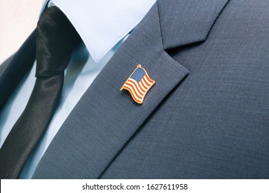 Man In Suit With Tie And USA Flag Pin At Chest Area