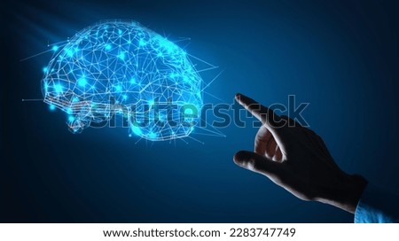 A man in a suit is touching a brain with a digital display.
