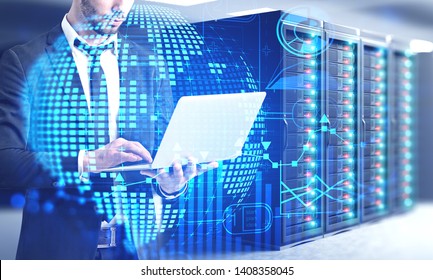 Man in suit using laptop computer in server room with double exposure of global business infographics hologram. Concept of market analysis and fintech. Toned image - Powered by Shutterstock