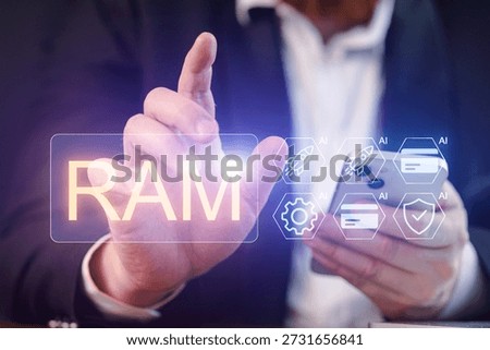 A man in a suit is using a smartphone while touching a glowing RAM symbol. There are various icons related to artificial intelligence around him.