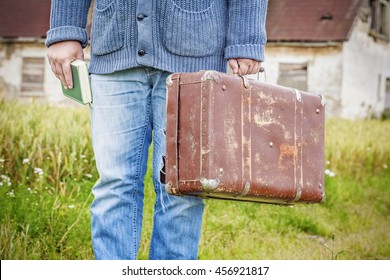 Man with suitcase and book