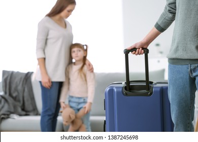 Man With Suitcase Leaving His Family