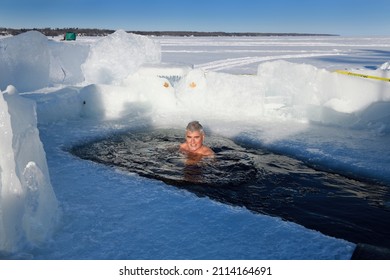 Man In Sun Swimming In An Ice Hole For A Cold Water Swim In Winter  At Kempenfelt Bay Lake Simcoe Barrie, Ontario, Canada - January 23, 2022