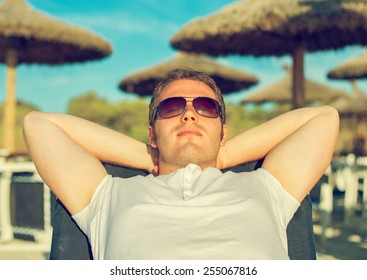 Man Sunbathing On The Beach Vacation.