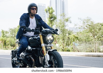 Man In Sunglasses And Helmet Riding Fast On Motorcycle On Highway