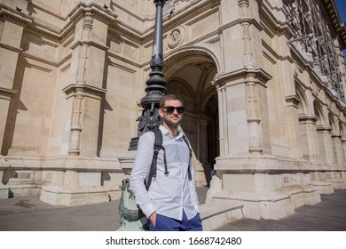man in sunglasses near an old building