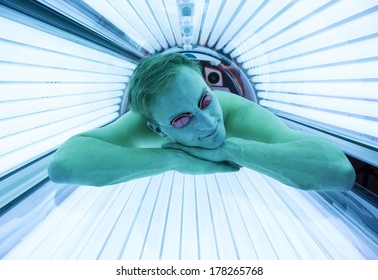 Man With Sunglasses On Tanning Bed In Solarium